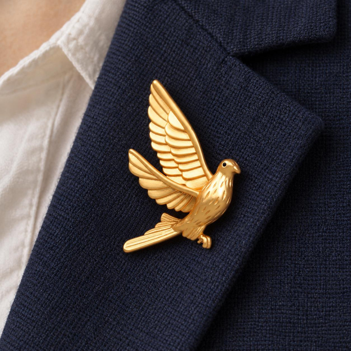 Brass dove brooch macro texture
