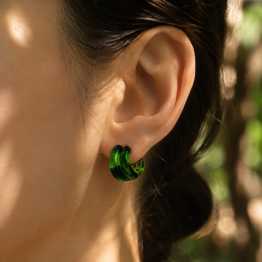 Green glass swirl stud earrings on gold posts