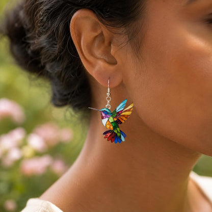 Hummingbird dangle earrings worn on model