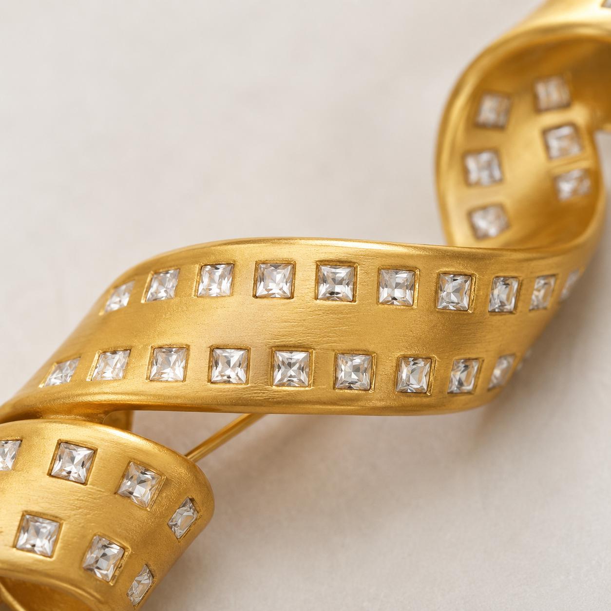 Gold spiral brooch worn on a coat lapel