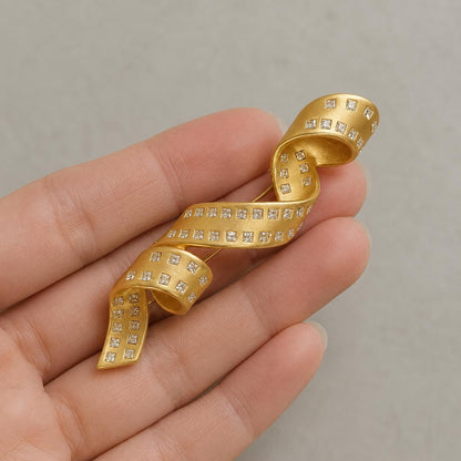 Gold spiral ribbon brooch - close-up detail