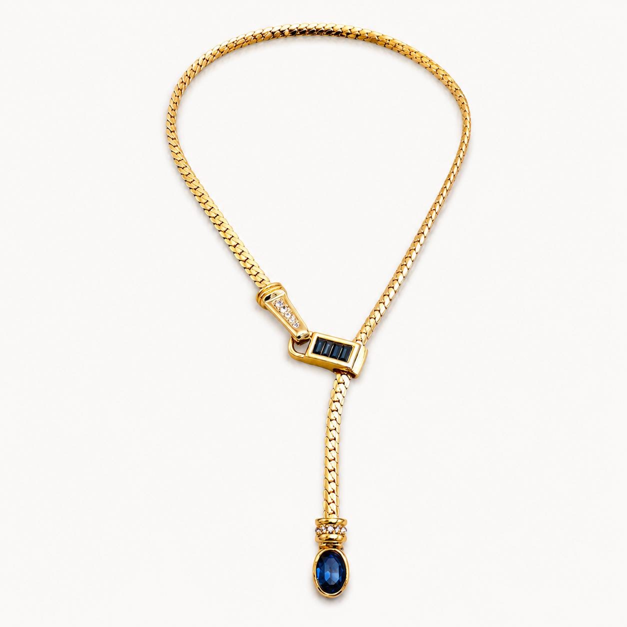 Gold Y lariat necklace on neutral background