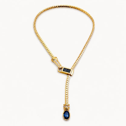 Gold Y lariat necklace on neutral background