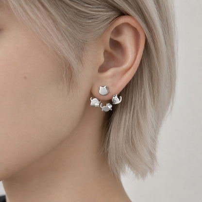 Cat ear jacket stud earrings on neutral background