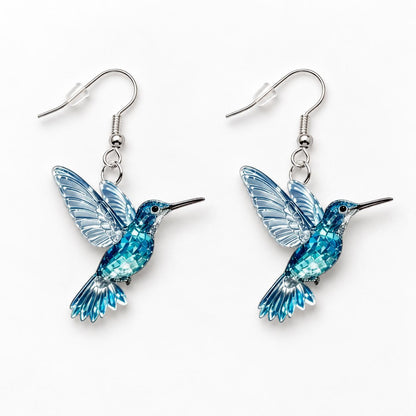 Blue hummingbird earrings worn on model