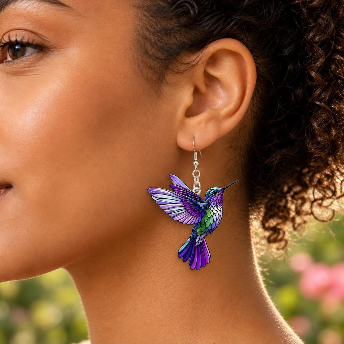 Purple hummingbird earrings flat lay