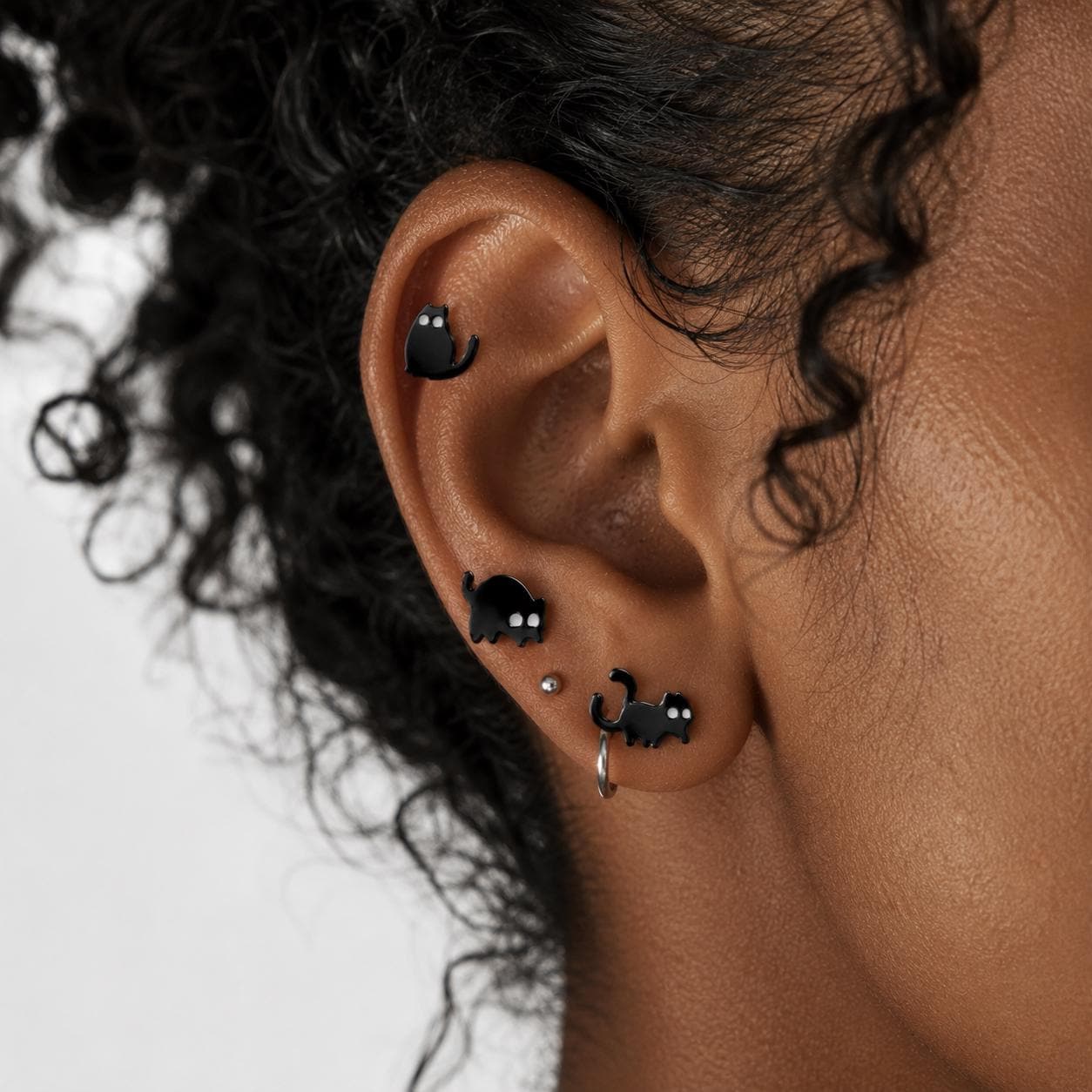 Black cat stud earrings worn on model
