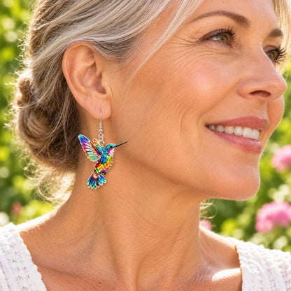 Stained glass hummingbird earrings on neutral background