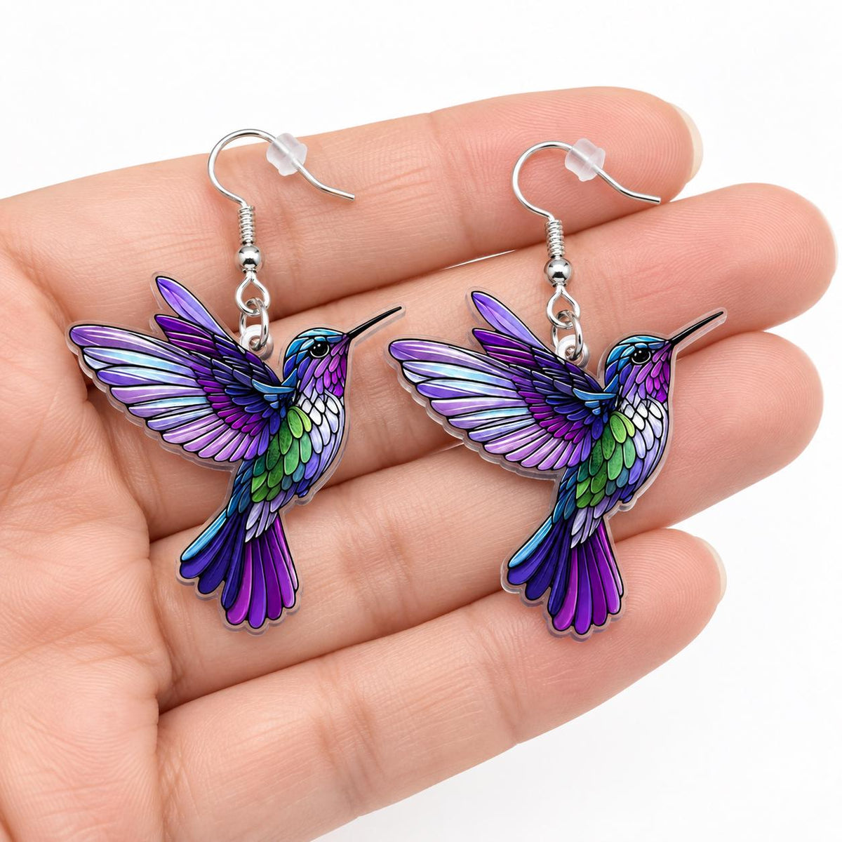 Purple hummingbird earrings worn on model