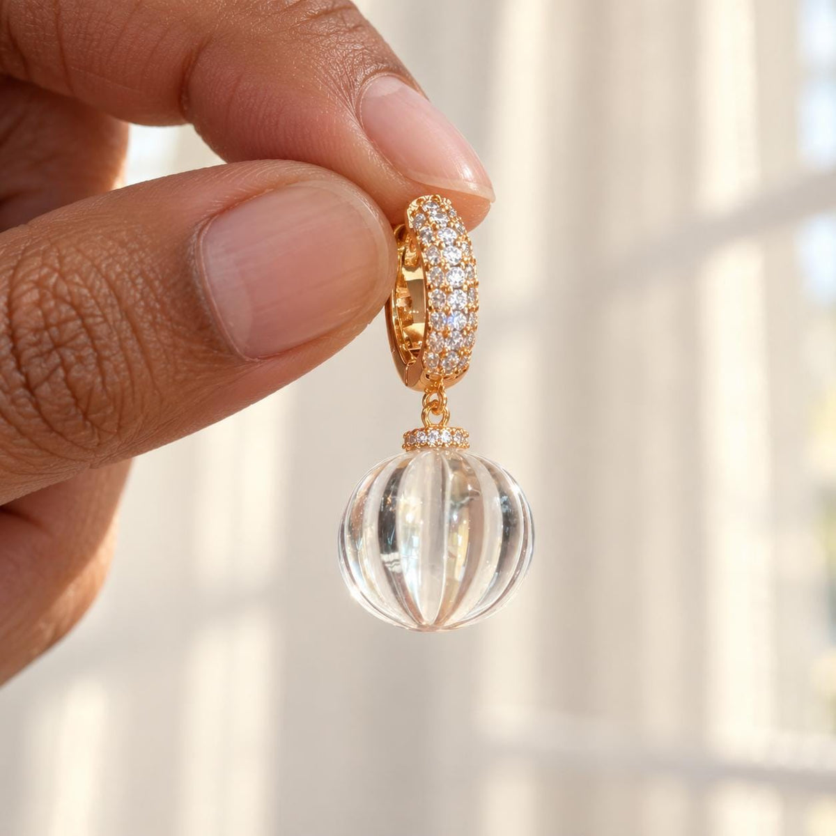 Clear glass bead earrings on neutral background