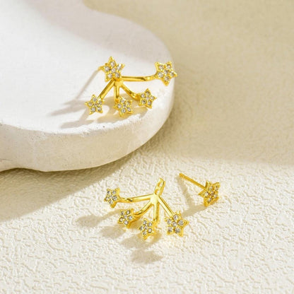 Star ear jackets worn as a single stud